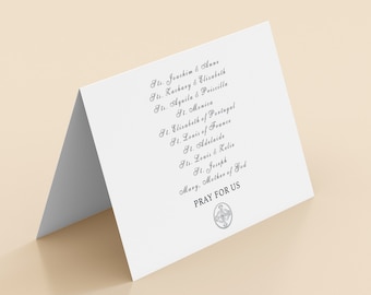 May include: White card with a list of saints' names in cursive script. The text reads: "St. Joachim & Anne, St. Zachary & Elizabeth, St. Aquila & Priscilla, St. Monica, St. Elizabeth of Portugal, St. Louis of France, St. Adelaide, St. Louis & Celine, St. Joseph, Mary, Mother of God. PRAY FOR US".