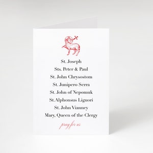 May include: A white card with a red image of a lamb with a cross on its head. The card lists the names of saints: St. Joseph, Sts. Peter & Paul, St. John Chrysostom, St. Junipero Serra, St. John of Nepomuk, St. Alphonsus Liguori, St. John Vianney, Mary, Queen of the Clergy. The card also includes the text "pray for us".