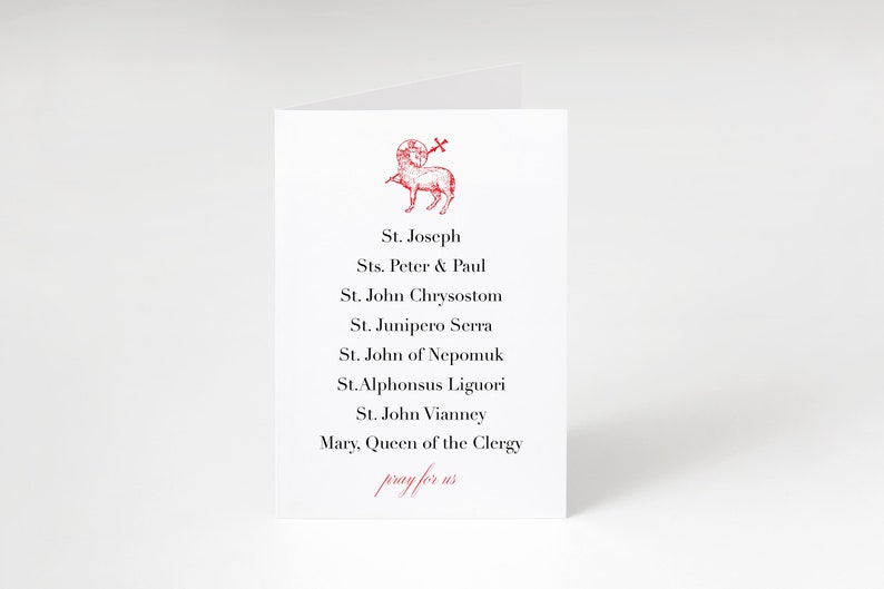 May include: A white card with a red image of a lamb with a cross on its head. The card lists the names of saints: St. Joseph, Sts. Peter & Paul, St. John Chrysostom, St. Junipero Serra, St. John of Nepomuk, St. Alphonsus Liguori, St. John Vianney, Mary, Queen of the Clergy. The card also includes the text "pray for us".