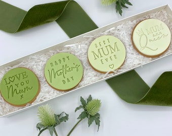 May include: A white gift box filled with four green and white decorated cookies. The cookies have different messages including "Love You Mum", "Happy Mother's Day", "Best Mum Ever", and "Mum A.K.A Queen".