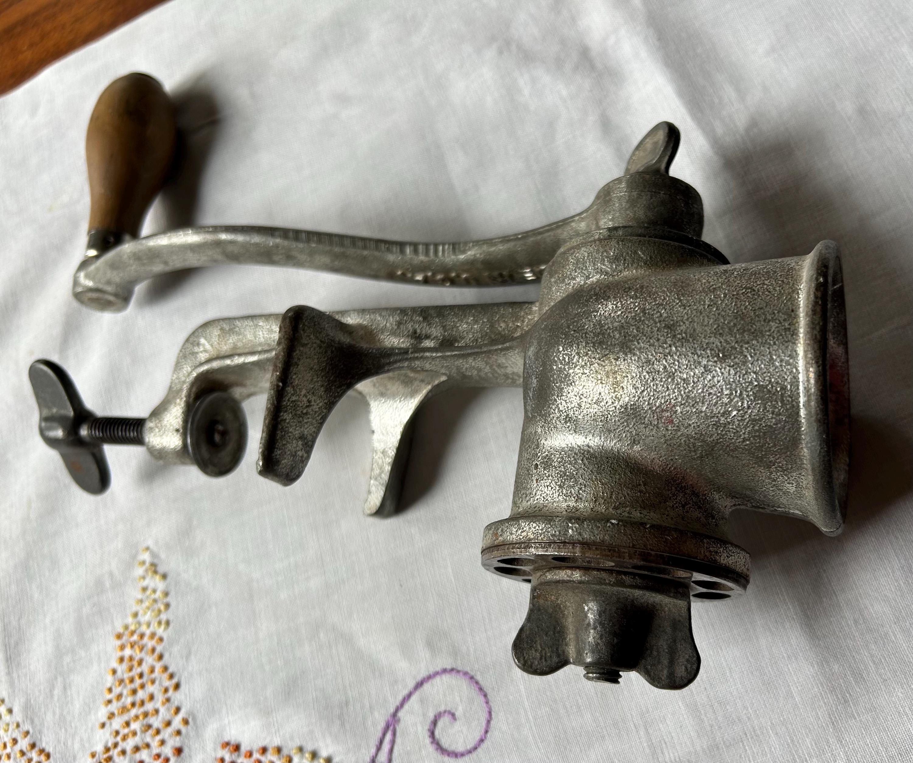 Vintage Climax 51 Hand Crank Food Meat Grinder. Attaches to tabletop. Metal with wood handle. Very heavy. Works. 9” wide, 11.5” tall.