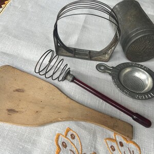 Very old kitchenware. Royal baking powder can with lid, pastry blender, wood butter paddle, coffee strainer, whisk early plastic handle.