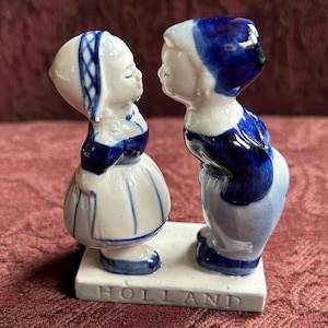 Delft Dutch boy and girl kissing figurine. 3.75” tall and 3” wide. Blue & white. Hand painted.