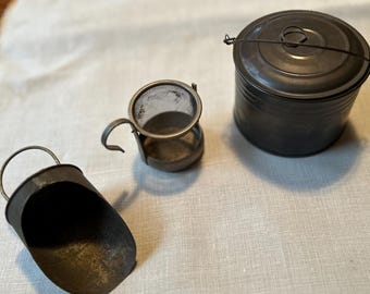 Primitive metal  kitchen tools. Small metal decorative pot, scoop and tilt strainer.