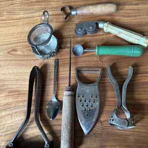 9 Vintage kitchen tools. Nut cracker, melon baller, slicers, grater, ice pick, tea strainer.