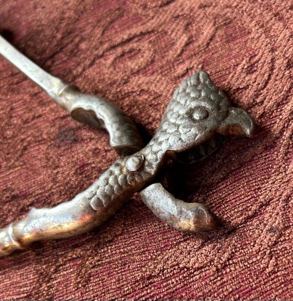 Vintage cast metal bird parrot head nutcracker. 7” long. Head 1.5”, handles 1.75” wide when closed. Heavy. Hand-held.