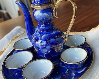 8 piece tiny tea set. Dark blue with 5.5” pot, 5 cups 1 7/8” and  6 3/4” plate. Tea party, anyone?
