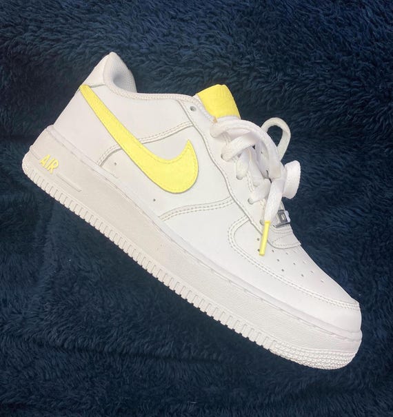 white nike air force with yellow tick