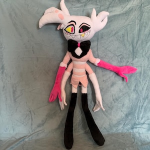 May include: A plush toy of a character with white fur, pink and white striped clothing, black boots, and pink and white arms. The character has a black bow tie and red eyes with yellow pupils.