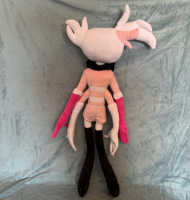 May include: A plush toy with pink and white fur, black legs, and pink and white arms. The toy has a pink and white striped shirt and a black collar.