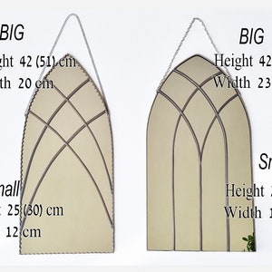 May include: Two arched mirrors with decorative metal frames. The larger mirror measures 42 inches by 23.5 inches, while the smaller mirror measures 25 inches by 12 inches. Both mirrors have a beige background.