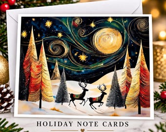 May include: A rectangular note card featuring a dark blue night sky with a large golden moon and swirling stars above a snowy landscape. Two black deer with patterned blankets stand among stylized trees in shades of red, gold, and grey.