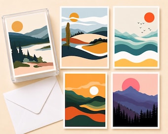 May include: A set of landscape art greeting cards featuring abstract designs with mountains, suns, and trees in shades of blue, orange, and green. The cards are displayed in a clear plastic box with a white envelope.