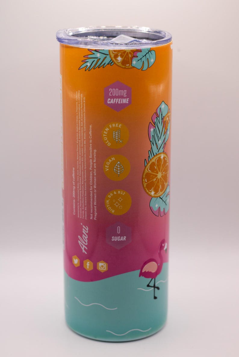 May include: A cylindrical tumbler with a gradient design, transitioning from orange to pink to teal. It features a flamingo graphic, orange slice illustrations, and text indicating 200mg of caffeine, gluten-free, vegan, and zero sugar.