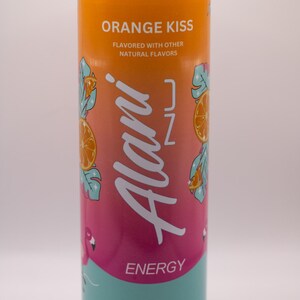 May include: A cylindrical, insulated tumbler with a gradient design of orange, pink, and teal. The tumbler features the text "ORANGE KISS" and "Alani Nu ENERGY" with orange slice and flamingo graphics. It is flavored with other natural flavors.