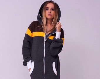 May include: A gray hooded jumpsuit with a yellow and brown stripe across the chest. The jumpsuit has a zipper closure and pockets.