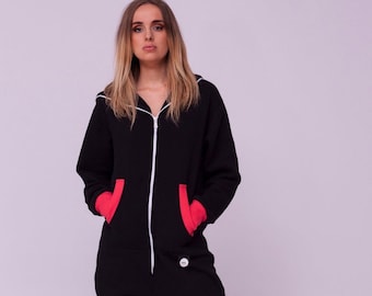 May include: Black hooded jumpsuit with red accents on the pockets and cuffs. The jumpsuit has a zipper closure and a white button on the front.