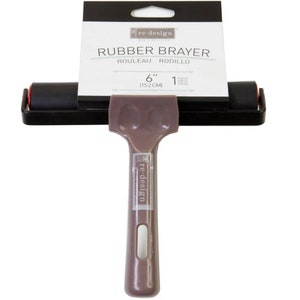 May include: A 6-inch rubber brayer with a brown plastic handle. The brayer is labeled "re-design" and is used for spreading paint or ink.