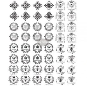 May include: A sheet of black and white decorative stamps featuring various designs, including crowns, wreaths, bees, and text. The text includes "Paris", "Les Alpes", "Beautiful", and "Bijouterie".