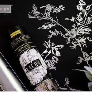 May include: A silver metallic transfer sheet with a floral design. The sheet is labeled "re-design Decor Transfers" and "Silver Bird Kacha".