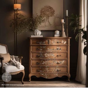 May include: A wooden dresser with six drawers, adorned with floral and butterfly decals. The dresser has a warm, natural wood tone and black hardware. The image also includes a chair, artwork, and the text "#670566 branch harmony".