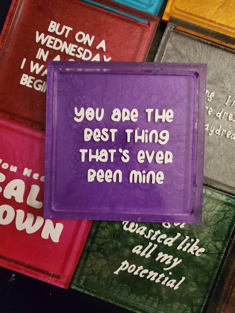 May include: Purple square coaster with white text that reads "You are the best thing that's ever been mine".