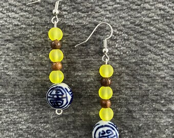 Dangle earrings with yellow frosted glass and blue and white ceramic beads