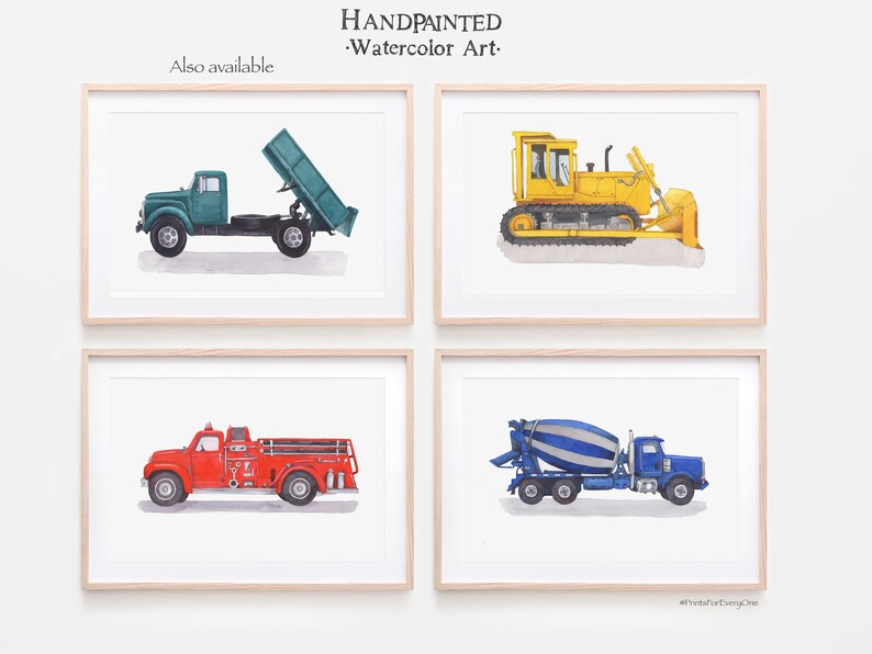 May include: Set of four watercolor prints featuring different construction vehicles. The prints are framed in a light wood frame and feature a green dump truck, a yellow bulldozer, a red fire truck, and a blue cement mixer.