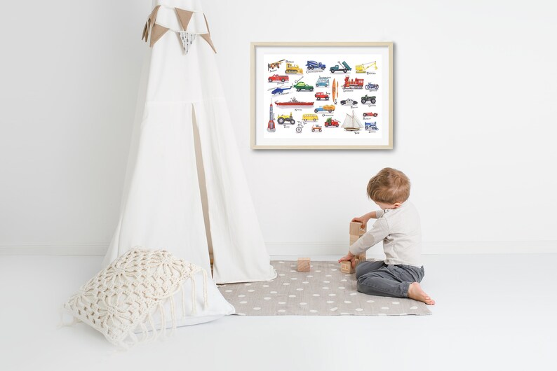 May include: A framed print of a colorful illustration of various toy vehicles, including cars, trucks, boats, and airplanes. A young child is playing with wooden blocks in front of the print.