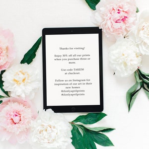 May include: A tablet screen displaying a sale announcement for art prints. The text reads "Thanks for visiting! Enjoy 30% off all our prints when you purchase three or more. Use code TAKE30 at checkout. Follow us on Instagram for inspiration of our art in their new homes @ifonlyaprilprints #ifonlyaprilprints"