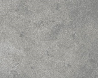 May include: A close-up of a gray, textured surface.