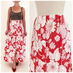 May include: A red maxi skirt with a white floral print and a button-up front. The skirt has a fitted waist and a flowing, A-line silhouette.