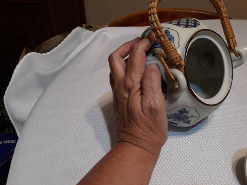 Blue and white Asian teapot with teacup