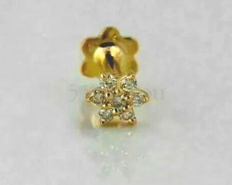 May include: A gold nose stud with a flower design featuring small clear diamonds.