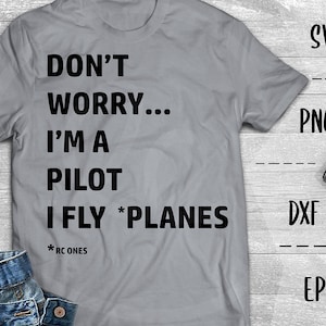 May include: A gray t-shirt with the text "DON'T WORRY... I'M A PILOT I FLY *PLANES *RC ONES" printed in black.