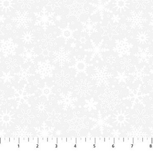 May include: White fabric with a repeating pattern of snowflakes in various sizes and designs. The snowflakes are outlined in white against a light gray background. A ruler is at the bottom, showing measurements in inches.