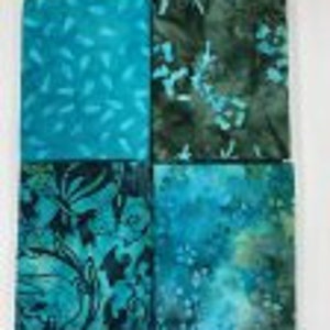 May include: Four fabric squares in shades of teal and green with various floral and abstract patterns.