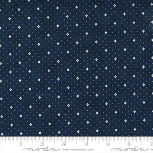 May include: Dark navy blue fabric with a repeating pattern of small white diamonds and dots. The fabric has a textured appearance and is suitable for quilting or sewing projects. The image includes a ruler along the bottom edge.