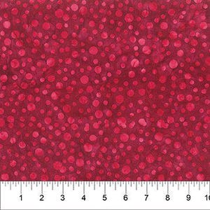 May include: Red fabric with a pattern of varying sized pink circles. The fabric is measured with a ruler in inches, showing a 10-inch width. The circles are scattered across the surface.