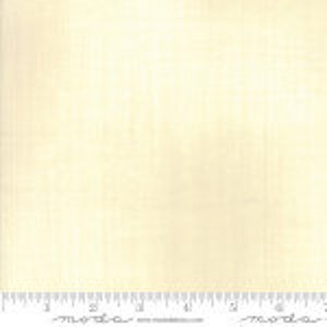 May include: A close-up of a white, textured fabric with a subtle sheen. The fabric has a smooth, even texture and a slightly off-white color.