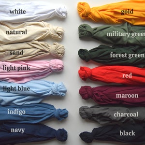 May include: A collection of fabric swatches in various colors, including white, natural, sand, light pink, light blue, indigo, navy, gold, military green, forest green, red, maroon, charcoal, and black.