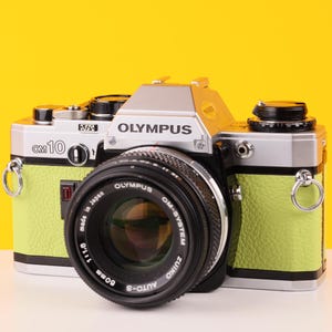 Olympus OM10 SLR 35mm Film Camera with Zuiko 50mm f1.8 Prime Lens Reconditioned with New Lime Leather Skin