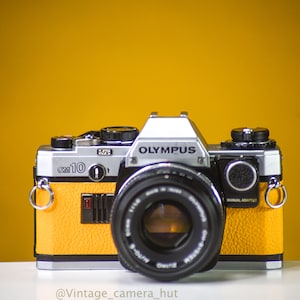 Olympus OM10 Vintage Film Camera with 50mm f/1.8 Lens and  Manual Adapter With New Leather Skin