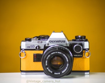 Olympus OM10 Vintage Filmkamera mit 50mm f/1.8 Objektiv und manuellem Adapter mit neuer Lederhaut
