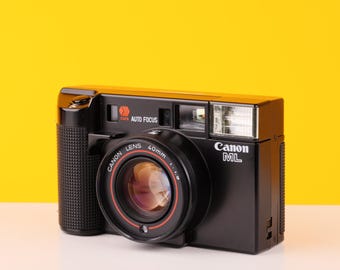 Cámara de película vintage Canon AF35ML, apuntar y disparar, con lente f/1.9 y estuche