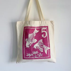 an original canvas color tote bag with dark purple vintage postage stamp style goldfish, japanese koi fish illustration, retro chinese lucky carp fish