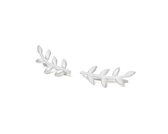May include: A pair of silver ear cuffs shaped like a delicate branch with leaves.