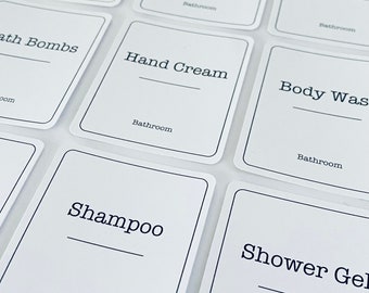 May include: White labels with black borders and text for bathroom organisation. The labels include: Bath Bombs, Hand Cream, Body Wash, Shampoo, Shower Gel, Cotton Wool, Cotton Buds, and Hand Wash.