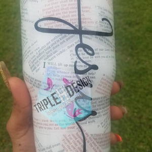May include: White tumbler with a black and blue floral design. The tumbler features a bible verse quote: "Blessed are the peacemakers, for they shall be called sons of God."