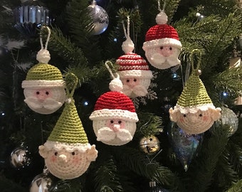 May include: Six crocheted Christmas ornaments, including Santa Claus and elves, hanging on a green Christmas tree.